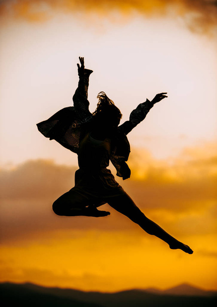 Passionate young woman dancer in a beautiful dreamy pose - Photo, Image
