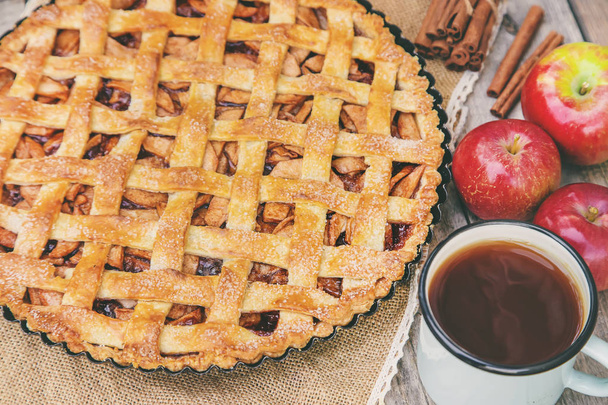 Pie with apples and cinnamon. Selective focus. - 写真・画像