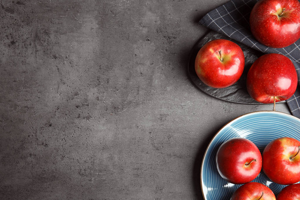 Flat lay composition with ripe juicy red apples on grey table. Space for text - Foto, afbeelding