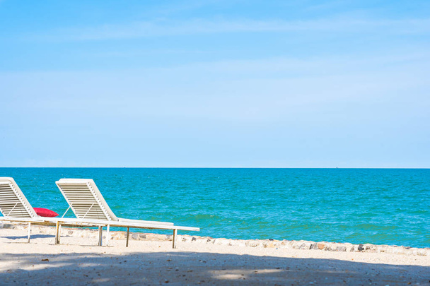 Beautiful umbrella and chair around beach sea ocean with blue sk - Φωτογραφία, εικόνα