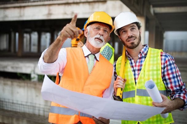 Construction engineers discussion with architects at construction site or building site - 写真・画像