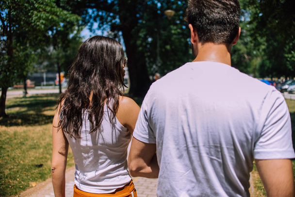 Portrait of affectionate couple taking a walk in summer park - Photo, Image