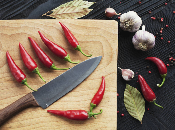 Knife chef  red chili pepper and spice on  wooden background - Фото, изображение