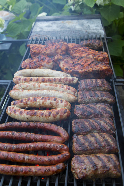    Cooking sausages and meat on an open fire - Foto, imagen