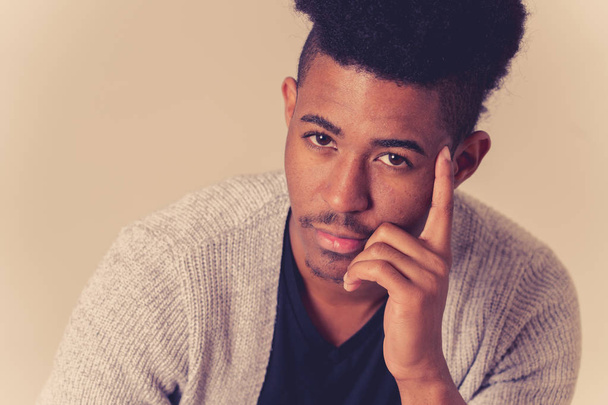 Portrait of young attractive stylish african american teenager man model posing in casual clothes against neutral background looking sexy with afro hair. In People Youth Beauty and fashion concept. - 写真・画像