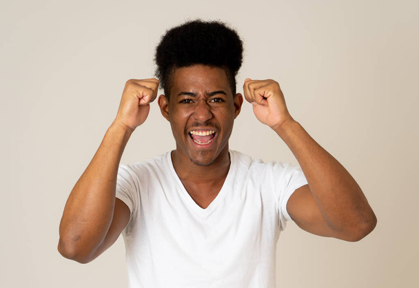 Amazed excited african american Man achieving his goal or wining. Shocked teenager laughing showing Victory gesture in Happy facial expression, Human emotions and happiness. Studio portrait isolated. - Valokuva, kuva