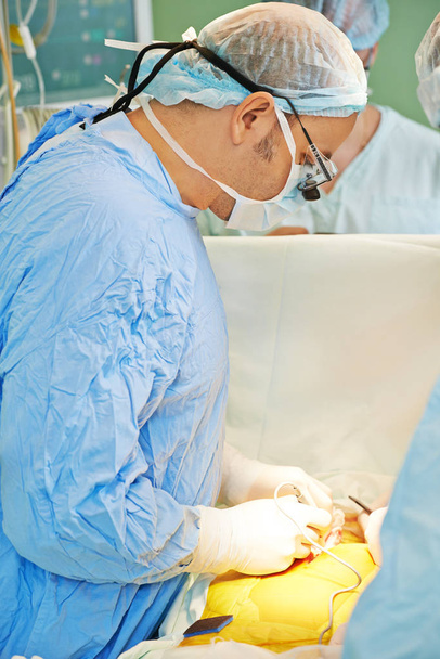 cardiac surgeon operating in surgery room - Photo, image