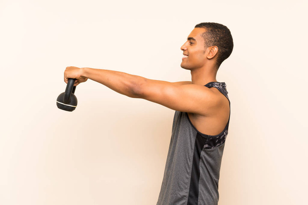 Sport man over isolated background with kettlebell - Foto, Imagem