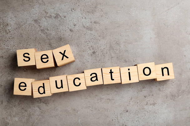 Wooden blocks with phrase "SEX EDUCATION" on stone background, flat lay - Фото, изображение