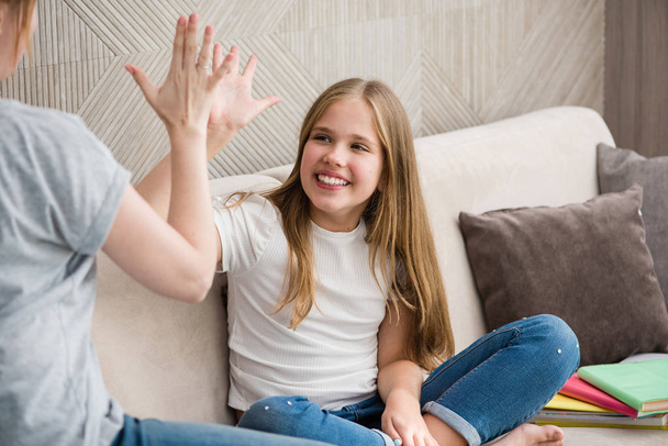 Cute girl and her mother are giving high five - Photo, Image