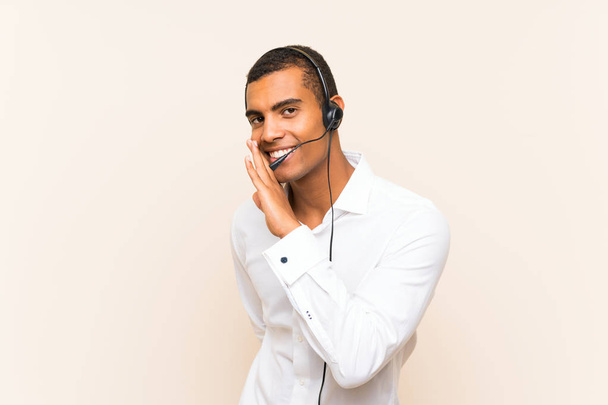 Young brunette man working with a headset whispering something - Foto, Bild