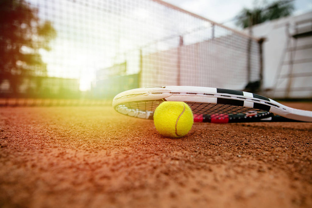 tennis racket. Close-up picture of equipment for tennis. Racket and ball are on the court. Sport concept. - Фото, зображення