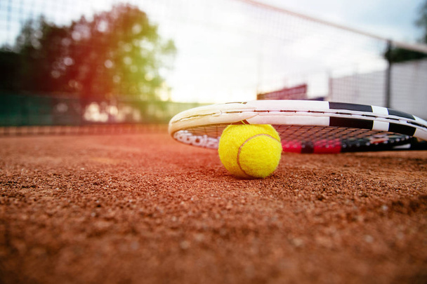 tennis racket. Close up view of tennis racket and balls on the tennis court. Sport, recreation concept. - Photo, image