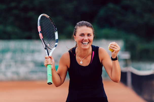 Winning emotion of tennis female player after match - Photo, Image
