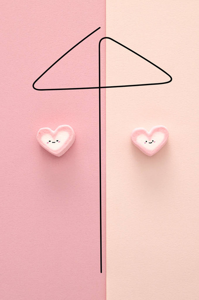 marshmallows shaped as hearts on pink background - Photo, image