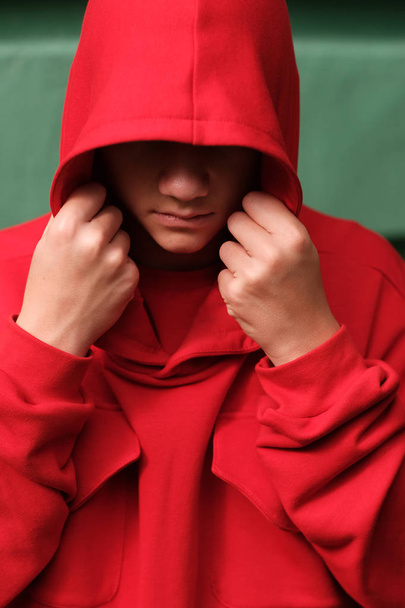 stylish casual teenage boy wearing fashionable red hoodie - Photo, image