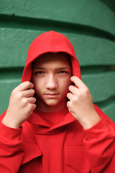 stylish casual teenage boy in fashionable red hoodie - Zdjęcie, obraz