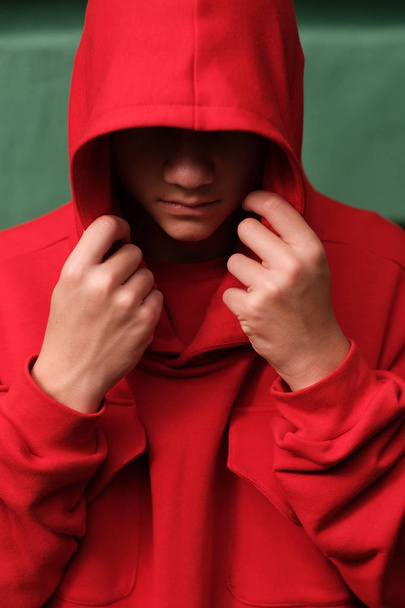stylish casual teenage boy wearing fashionable red hoodie - Foto, imagen