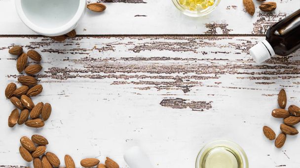 almonds with almond butter and mortar on a wooden background - Photo, Image