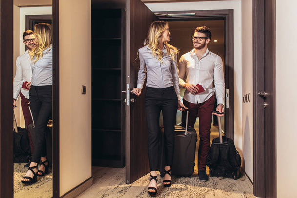Vacation for couple. Young couple entering the hotel room togeth - 写真・画像
