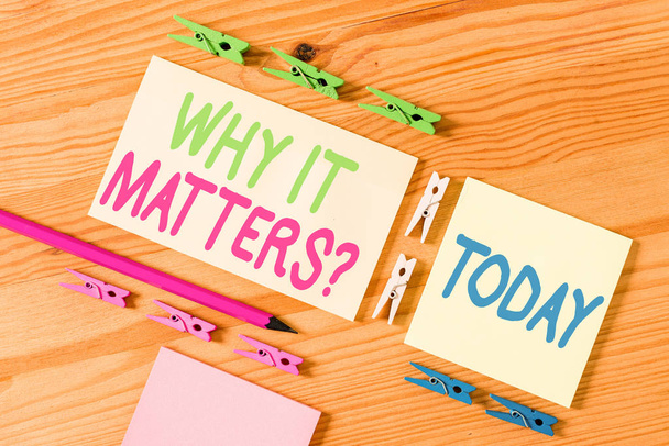 Handwriting text Why It Matters Question. Concept meaning most important thing to be done when involved in situation Colored clothespin papers empty reminder wooden floor background office. - Photo, Image