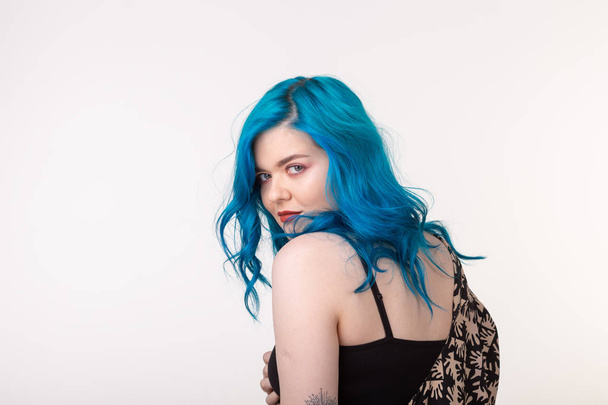 people, fashion and hair concept - beautiful girl with blue hair standing on white background with copy space - 写真・画像