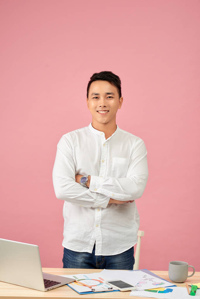 Portrait of confident Asian man  standing with his arms folded and looking at camera - Фото, изображение