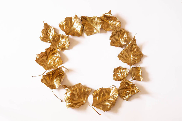 Autumn composition. Wreath made of gold leaves on white background. Fall concept - Фото, изображение
