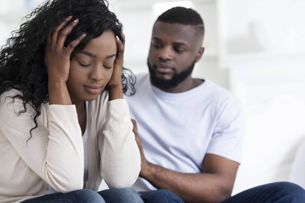 Loving african man soothing upset girlfriend, apologizing after quarrel - Photo, Image