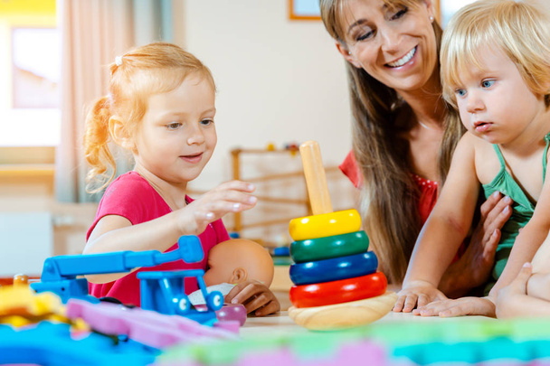 Children in nursery school learning and playing - Photo, Image