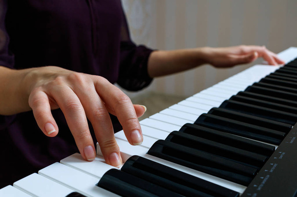 νεαρή γυναίκα που παίζει πιάνο - Φωτογραφία, εικόνα
