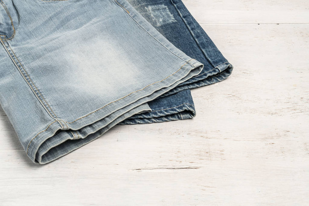 jean skirts on a wooden background with copy space - Photo, Image