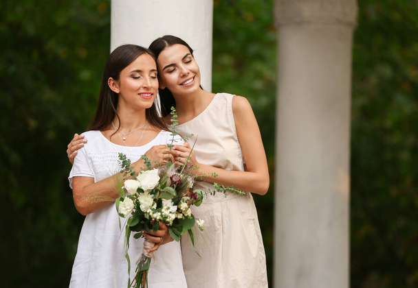 Beautiful lesbian couple on their wedding day outdoors - Photo, Image