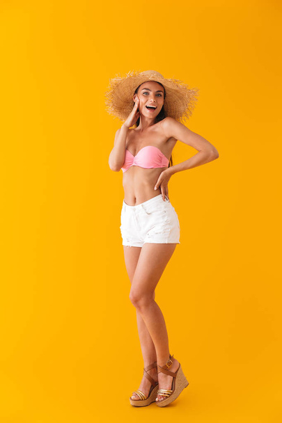 Attractive cheerful young girl wearing bikini standing - Photo, image
