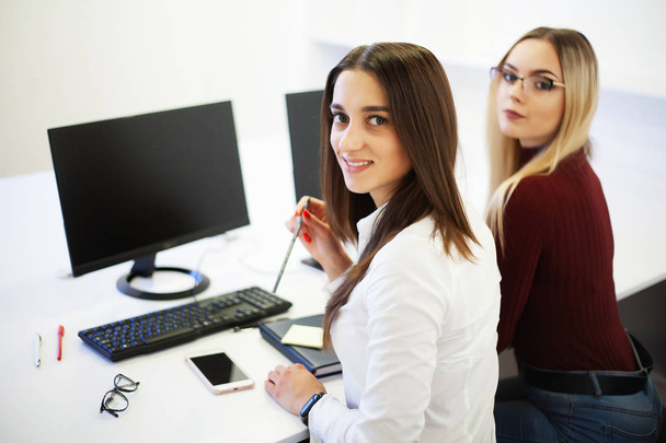 Two female colleagues in office working together. - Photo, Image