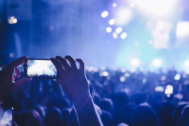 People taking photographs with touch smart phone during a music  - Photo, Image