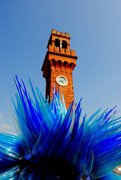 Sreet art, glass, crystal sculture with the clock tower in Murano, Venice, Italy. artist Simone Cedenese. San Pietro Martire church. - Photo, Image