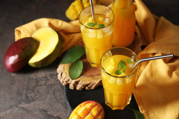 Glasses of fresh mango juice on table - Фото, изображение
