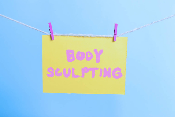 Conceptual hand writing showing Body Sculpting. Business photo text activity of increasing the body s is visible muscle tone Clothespin rectangle shaped paper reminder white wood desk. - Photo, Image
