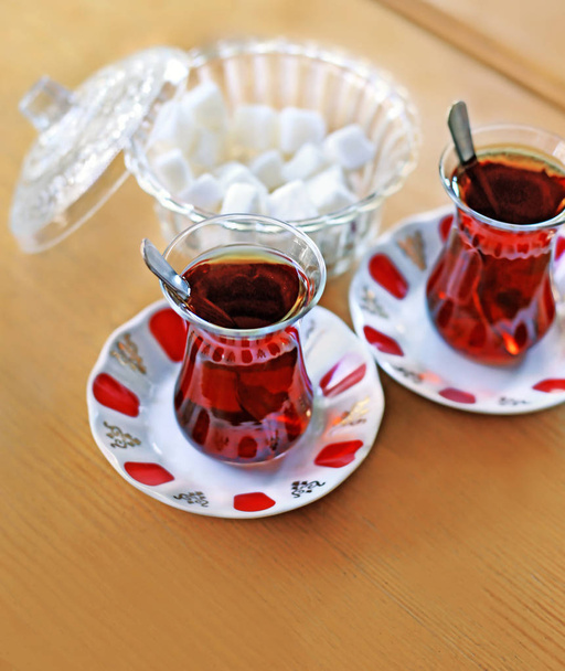 traditional turkish tea with sugar on wooden table - Фото, изображение