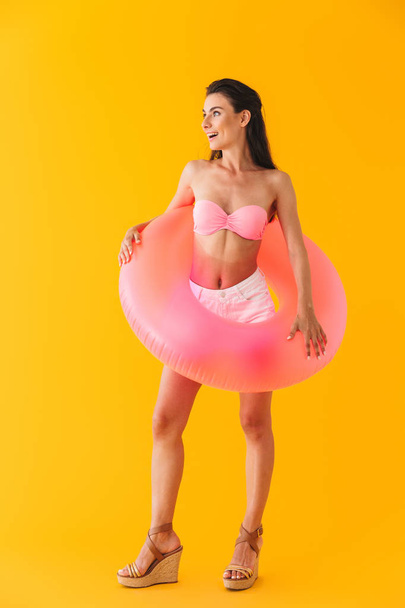 Attractive cheerful young girl wearing bikini standing - Foto, Imagen
