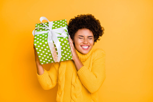 Photo of funny cute charming sweet lovely girlfriend hearing sound out of her gift box smiling toothily laughing wearing sweater holding box with hands isolated vivid color background - Fotografie, Obrázek