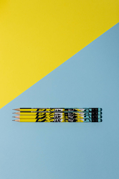 Pencils sharpened on a yellow and blue background - Foto, Imagen