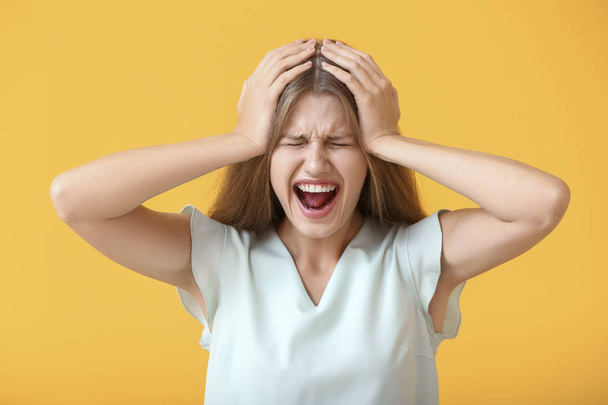 Stressed young woman on color background - Photo, image