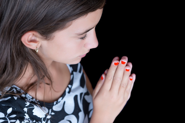Hispanic girl praying with her eyes closed - Zdjęcie, obraz