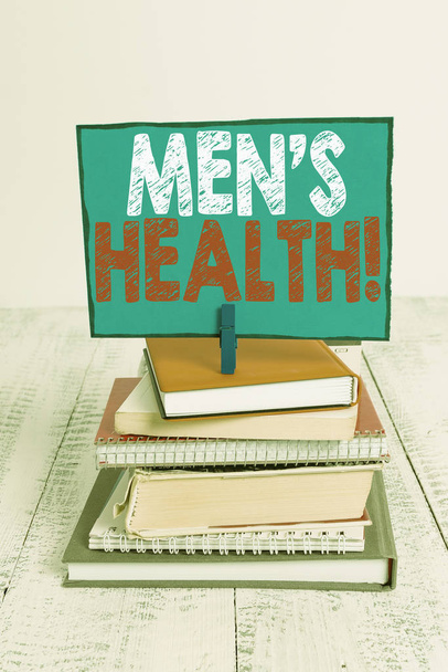 Writing note showing Men S Health. Business photo showcasing state of complete physical mental and social well being by analysis pile stacked books notebook pin color reminder white wooden. - Photo, Image