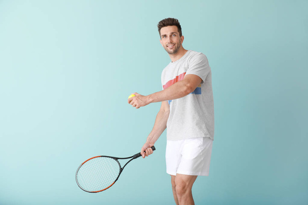 Handsome tennis player on color background - Valokuva, kuva