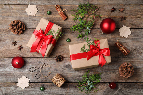 Flat lay composition with Christmas gifts and decoration on wooden background - Фото, зображення