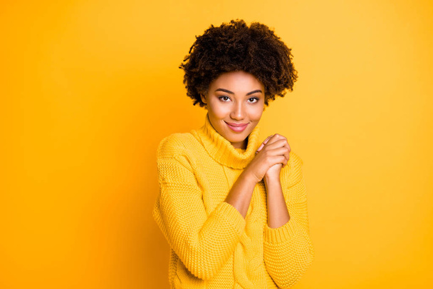 Photo of pretty dark skin lady looking on little puppy overjoyed wear warm knitted jumper isolated yellow background - Foto, afbeelding