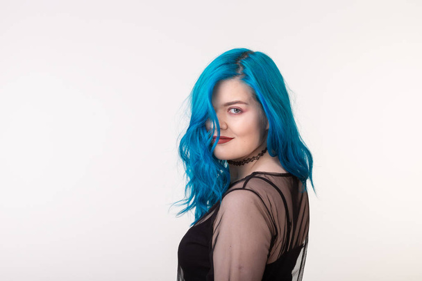 People and fashion concept - Beautiful woman with blue hair posing over white background - Foto, imagen